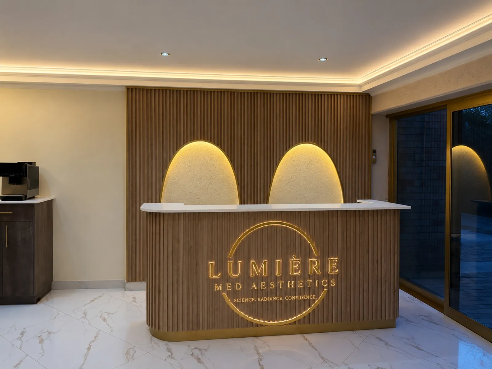 Lumiere Med Aesthetics gold logo on marble background